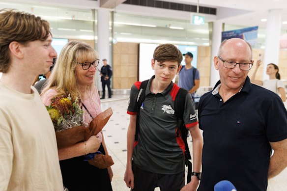 Ryan Trevithick (second from right) is reunite with his family, after his Barker College robotics team were stranded while on their way to Turkey.