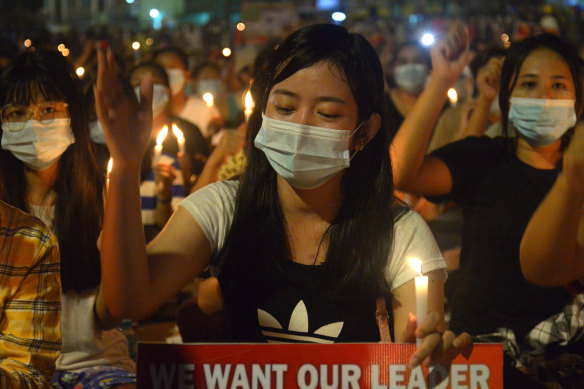 Protesters attend a candlelight night rally in Yangon on Saturday night. 