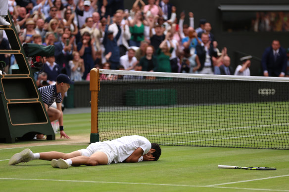 Carlos Alcaraz collapses onto the grass after overcoming Novak Djokovic to win last year’s Wimbledon men’s singles final.
