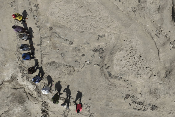 An aerial view shows a research team standing alongside the fossil footprint trackway at the excavation site on the eastern side of Lake Turkana in northern Kenya, 2022.