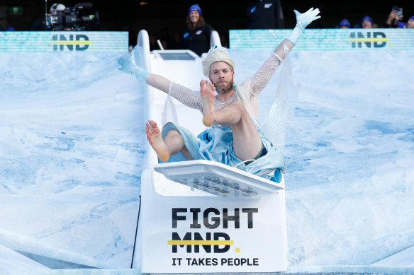 Hamish Blake speeds down the Big Freeze slide at the eighth FightMND fundraising event.