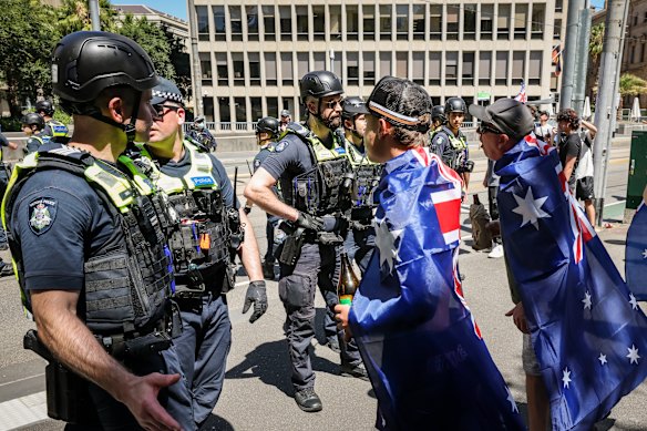 Police and March for Australia protesters in Melbourne on Monday.
