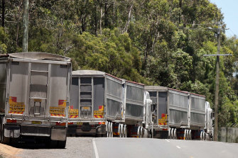 The queue: Trucks with NSW licence plates carrying construction waste line up outside Cleanaway's Willawong recycling facility on Brisbane's southside.