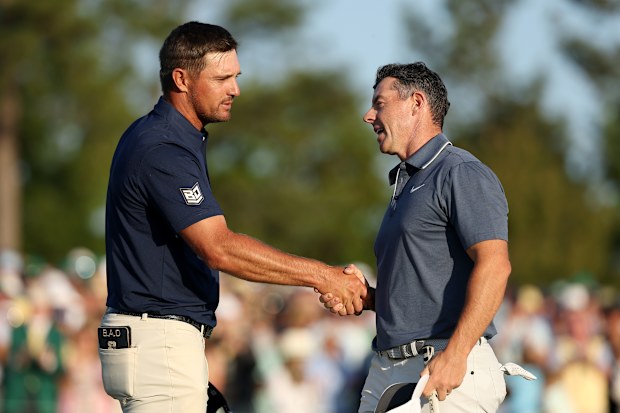 Bryson DeChambeau congratulates Rory McIlroy on his Masters win,