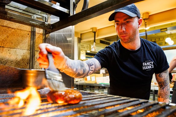 Chef Jarrod Di Blasi tending to Fancy Hank’s lamb sausage.