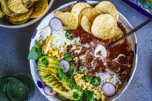 Taco soup with all the toppings.