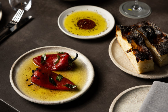 A snack-heavy menu includes marinated peppers with curry leaf and house-baked focaccia.