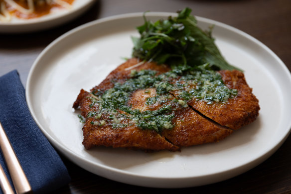 Chicken Kyiv, a crumbed schnitzel that comes with a jug of garlicky, herb-flecked butter.
