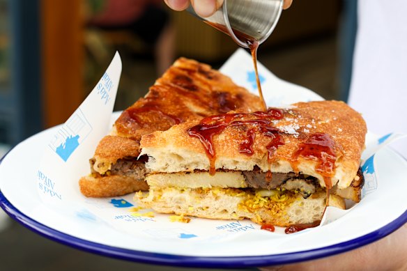 Hot honey adds a finishing touch to the babi guling toastie at Ada’s Affair Glebe.