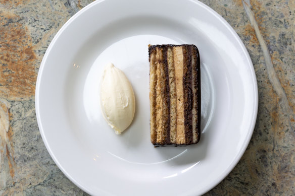 Opera cake with layers of almond sponge, buttercream and ganache.