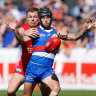 Caleb Daniel fights for the ball with typical ferocity on Sunday against Gold Coast’s Nick Holman.