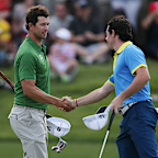 Rory McIlroy, right, of Northern Ireland shakes hands with Australia’s Adam Scott.