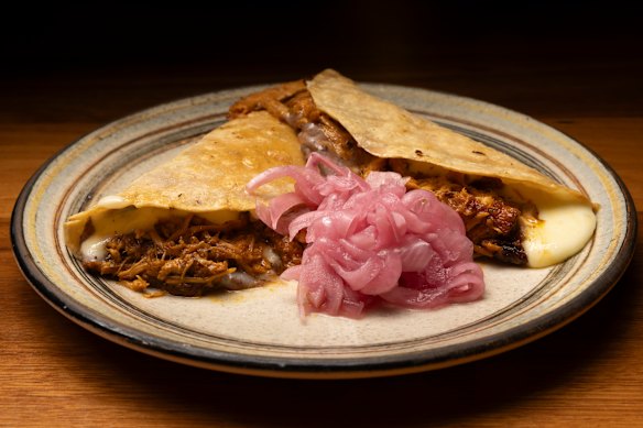 Quesadillas dorados with conchinita pibil (slow-cooked pork).