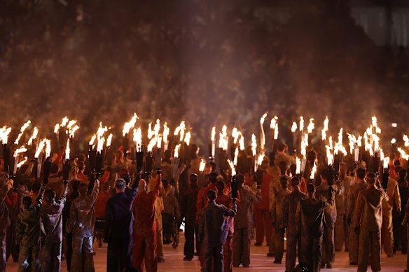 Torchbearers perform during the opening ceremony.
