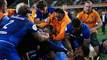 Marco Riccioni of Italy scuffles with Miles Amatosero of the Wallabies on the sideline.