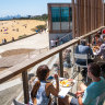The deck at Beach House gazes over the sands and bathing boxes of Brighton Beach.