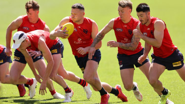 Steven May and his Demons teammates train the day before the grand final.