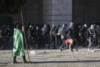 Palestinians clash with Israeli security forces at the Al-Aqsa Mosque on Friday.