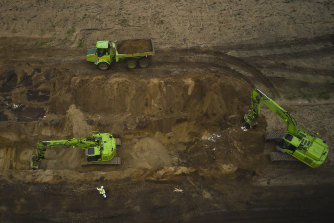 Buried mink are excavated in a trial excavation for the animals to be incinerated, at a military area close to Noerre Felding, Denmark, in May.