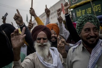Farmers celebrate at a protest site on the Delhi-Haryana border crossing in Singhu, Delhi, India after Prime Minister Narendra Modi made his biggest policy reversal since assuming power in 2014, scrapping controversial farm laws.