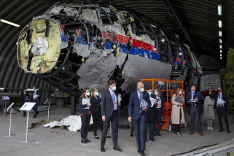 Presiding judge Hendrik Steenhuis, centre, and other trial judges and lawyers view the reconstructed wreckage of Malaysia Airlines Flight MH17.