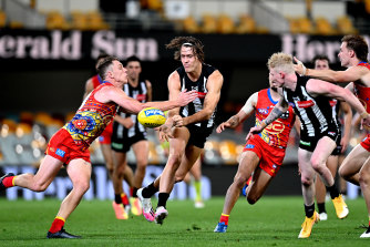 Magpies defender Darcy Moore under pressure.