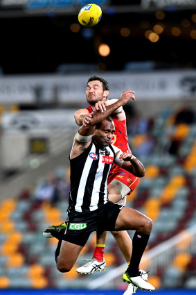 Collingwood's Travis Varcoe is spoiled by Jarrod Harbrow of the Suns.