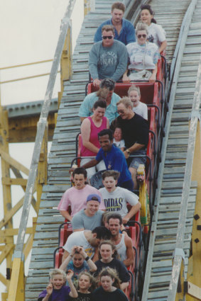 Patrons ride the Scenic Railway at Luna Park’s 80th birthday celebrations.