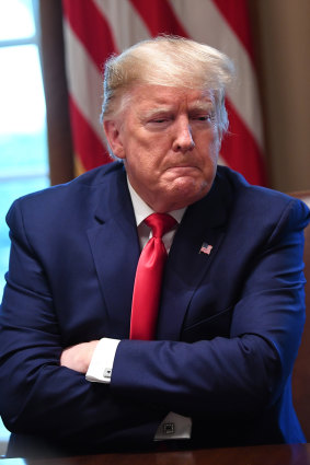 US President Donald Trump listens during a meeting with the Coronavirus Task Force and pharmaceutical executives in the Cabinet Room of the White House on Monday.