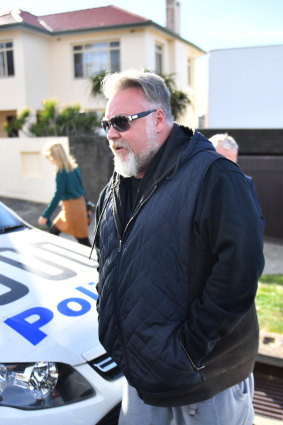 Kyle Sandilands arrives at John Ibrahim's house during a police operation on Tuesday.