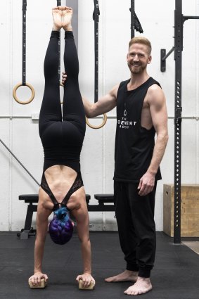 Professional acrobat Brendan Irving supports Jade Twist during a handstand.