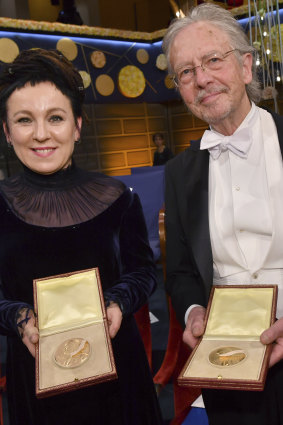 Literature laureates Olga Tokarczuk and Peter Handke pose with their Nobel medals at the Nobel Prize award ceremony.