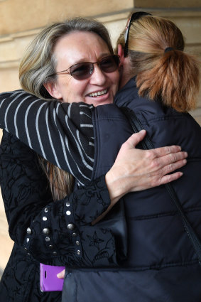 Jenny Hallam is seen with a supporter outside the District Court of SA on Thursday.
