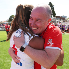 Swans head coach Scott Gowans celebrates the victory with co-captain Chloe Molloy.