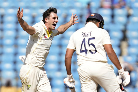 Pat Cummins celebrates after the dismissal of Rohit Sharma.