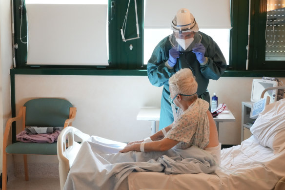 A doctor checks a COVID-19 patient in Italy in February. 