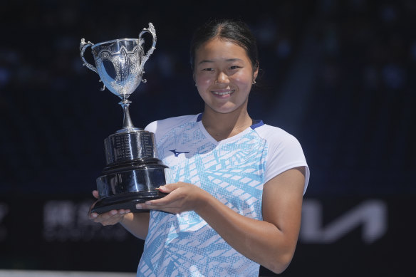 Wakana Sonobe of Japan holds her trophy after defeating Kristina Penickova of the U.S. during the girl’s singles final.