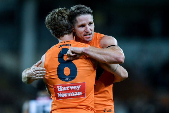 Hogan and Callan Ward celebrate the Giants’ win over Port Adelaide.