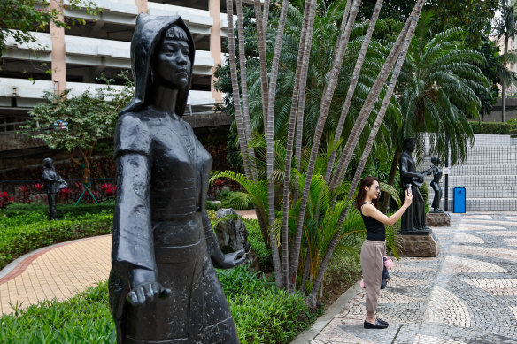 A woman takes a selfie at the Sculpture Park of the Chinese Ethnics in Macau. 