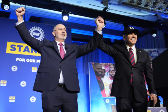 President Joe Biden stands with Shawn Fain, president of the United Auto Workers, at the union’s political convention.