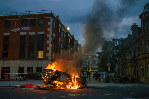 A police car is set on fire as Far-right activists hold an Enough is Enough protest in Sunderland.