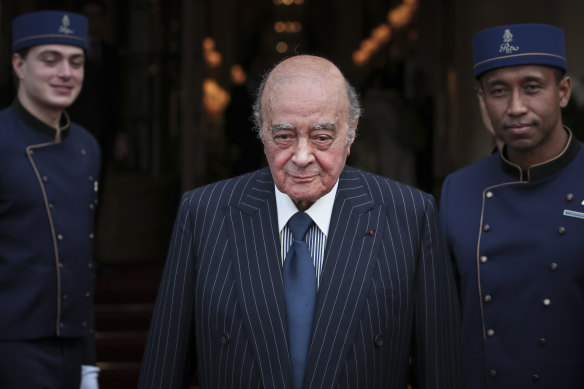 Egyptian businessman and Ritz hotel owner Mohamed al-Fayed poses with his hotel staff in Paris in 2016.