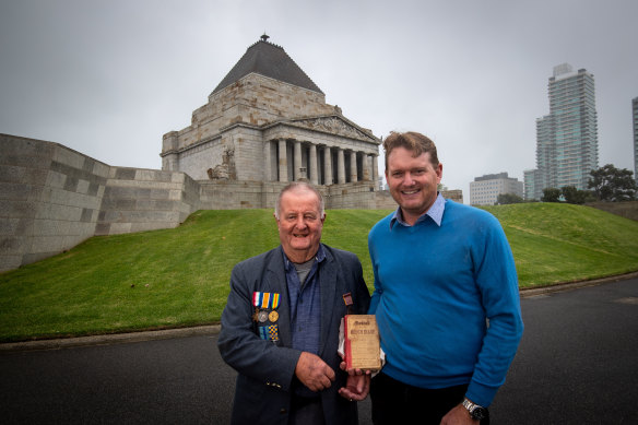 Thank you: Clark Pettigrew, right, hands the World War I diary of Morris Milliken to Morris’s nephew, Malcom Milliken at Melbourne’s Shrine of Remembrance.