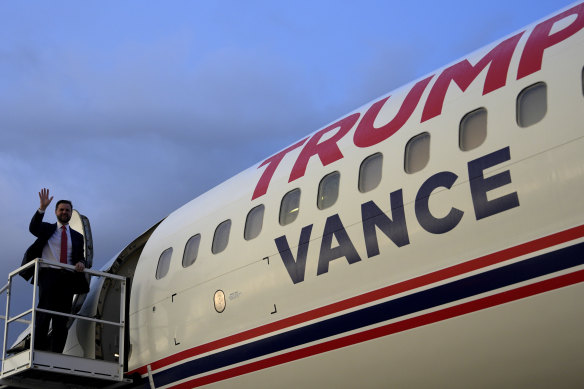 Republican vice-presidential candidate Senator J.D. Vance waves as he boards Trump Force Two.