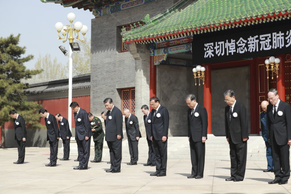 Chinese President Xi Jinping, fourth from left in front row, with other Chinese leaders during national mourning for victims of coronavirus at the Zhongnanhai Leadership Compound in Beijing on Saturday, April 4.