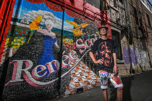 Artist Colin Sheppard with his mural of late drag queen Renee Scott in Little Grey Street, St Kilda.