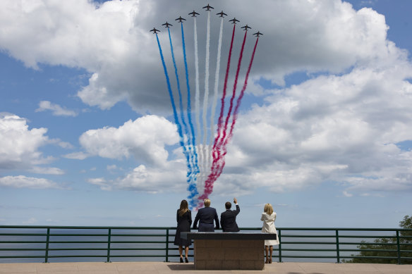 USPresident Donald Trump, Melania Trump, left, French President Emmanuel Macron, second right, and his wife Brigitte Macron, right, watch the fly-past