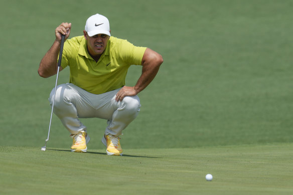 Brooks Koepka lines up a putt on the second hole.