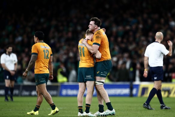 Wallabies’ players console each other after losing to Ireland.