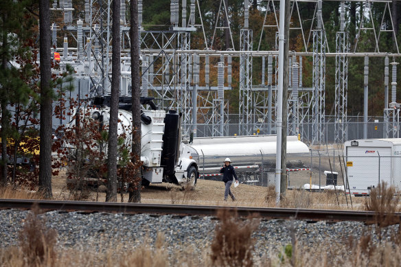 Workers work on a substation in North Carolina where a serious attack on critical infrastructure has caused a power outage to many people in December 2022. 